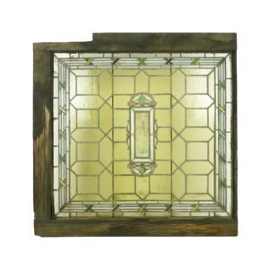 Victorian stained glass skylight with a wooden frame, featuring a yellow geometric pane pattern and a central decorative panel.
