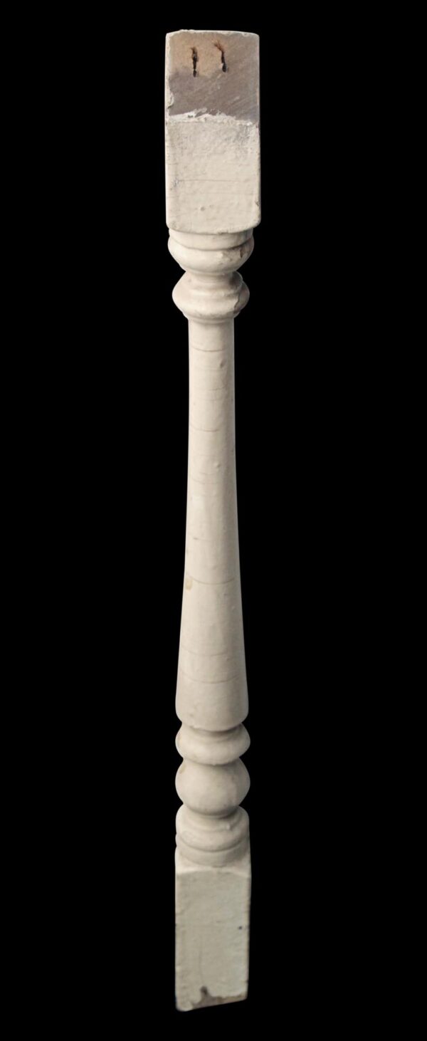 Antique white wooden stair spindle with carved turned sections shown vertically.