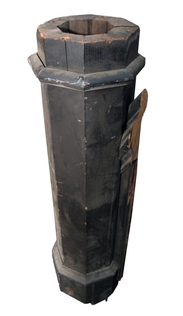 Antique traditional octagon wood staircase newel post shown in full length, with a dark wood tone and worn reclaimed finish, featuring a missing cap and visible side bracket.