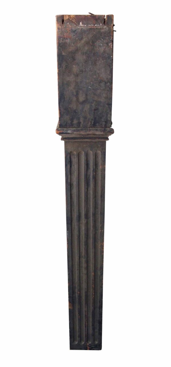 Antique fluted wooden staircase newel post in a dark wood tone, shown upright with carved vertical grooves and a squared top.