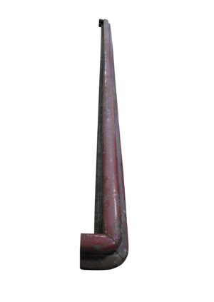 Close-up of a brown wooden banister handrail with a rounded end and spindle holes visible along the length.