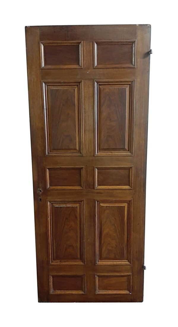 Antique walnut passage door with 10 panels on one side, shown upright with a dark wood tone and visible hardware cutouts on the edge.
