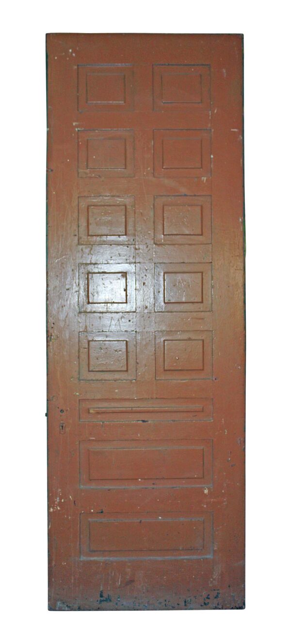 Tall antique wooden passage door with 13 panels shown on the brown side, with the original mortise lock visible near the left edge.