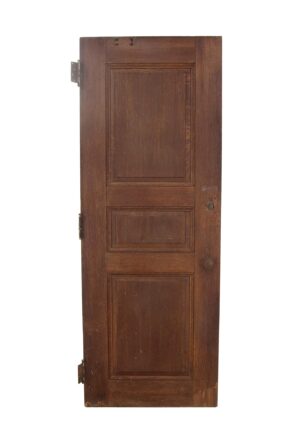 Three-panel oak door with a dark wood tone and visible wear at the bottom.