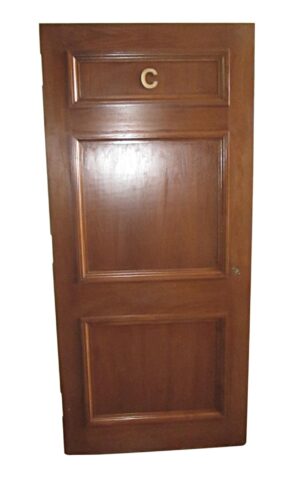 Three-panel wood door with a letter C near the top panel.