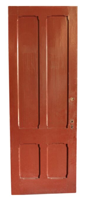 Antique four-panel interior door shown front-on, with two tall upper panels and two smaller lower panels, and no hardware visible.