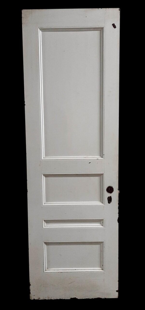 White painted wooden door with four recessed panels and visible wear, shown full length.