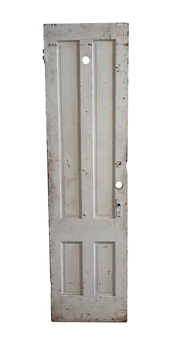 Tall wooden door with four vertical panels, shown in white with worn paint and a few original hardware pieces attached.