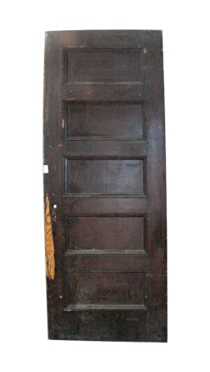 Dark wood tone door with five recessed panels shown front-facing, featuring minor cosmetic scrapes and scratches.