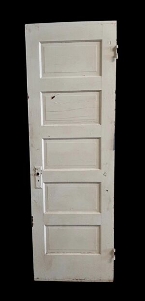 White wooden passage door with five recessed panels and some original hardware attached, shown standing upright and slightly angled.
