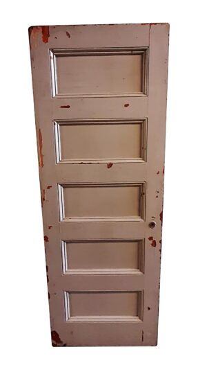Wooden passage door with five horizontal panels, shown in pale pink with some worn paint and a visible hardware piece near the lower right.