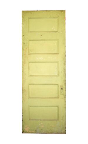 Antique wood passage door with five horizontal panels and a visible keyhole plate on one side.