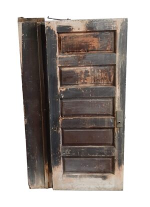 Antique wooden passage door with jamb, showing five raised horizontal panels and a distressed dark wood tone in restorable condition.