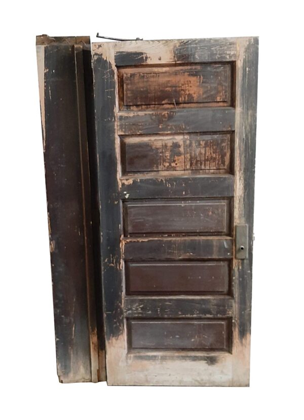 Antique wooden passage door with jamb, showing five raised horizontal panels and a distressed dark wood tone in restorable condition.