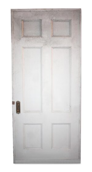 White wood passage door with six recessed panels and an original key plate on the left side.