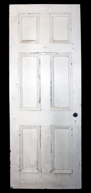 Antique six-panel white wood passage door shown front-on, with three stacked pairs of recessed panels and a plain lower edge.