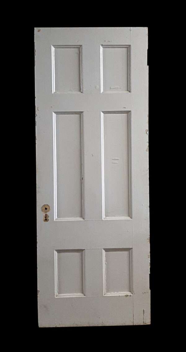 White six-panel wooden passage door with recessed rectangular panels and a worn surface, shown upright in a front view.