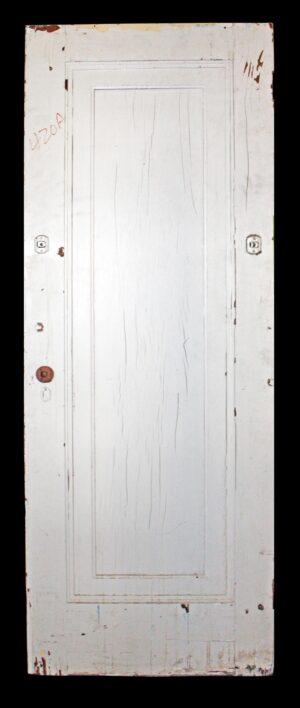 Antique white wood passage door with one vertical panel and visible hardware holes, shown front on.