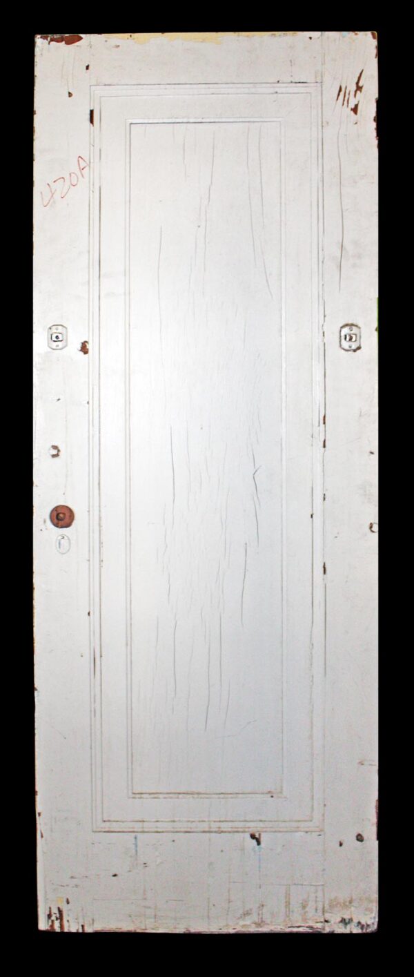 Antique white wood passage door with one vertical panel and visible hardware holes, shown front on.