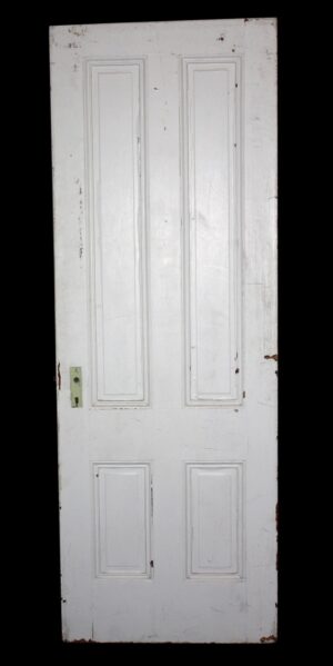 A white four-panel passage door shown front-on, with visible wear and no hardware installed.