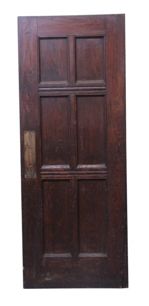 Dark wood tone oak door with six panels and a rectangular latch plate on the left side.