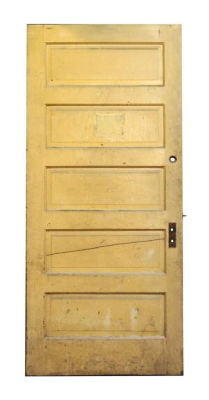 Five-panel wooden door with a tan painted side, showing rectangular recessed panels and worn surface details.