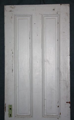 Antique white painted wood passage door with four recessed panels, shown full length with worn edges and no hardware.