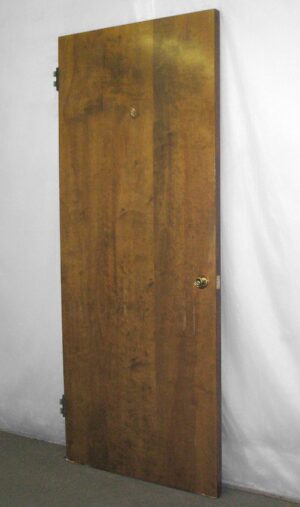 1940s maple passage door shown upright with a dark wood tone, a plain flat surface, and visible hardware holes.