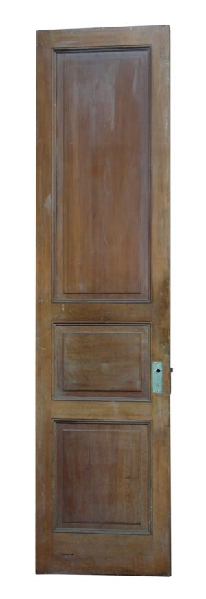 Three-panel narrow wood door with a dark wood tone and visible latch cutout on the right edge.