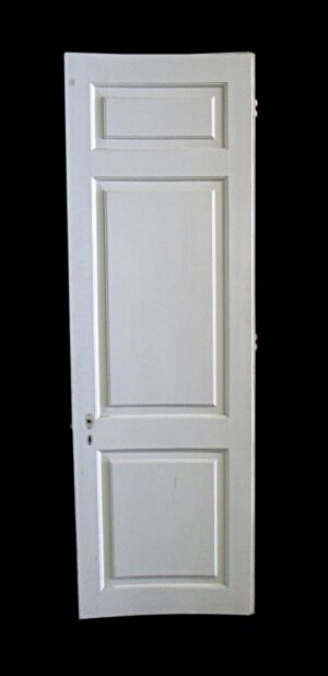 White wooden passage door with three raised panels and some original hardware attached.