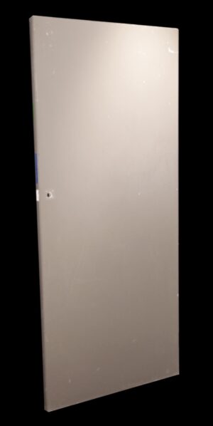 Plain tan wooden passage door with a smooth flat surface and no panels, shown at a slight angle.