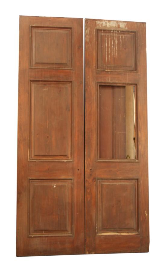 Pair of three-panel wooden doors in a dark wood tone, shown together with one door missing its center panel.
