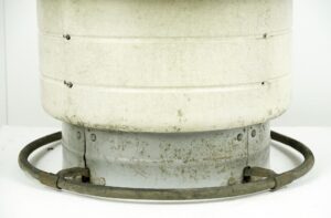 Close-up of a reclaimed foot control hand wash fountain showing the lower metal base with wear and a circular foot ring around it.