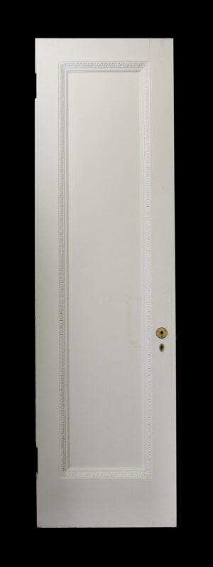 White wood passage door with one tall panel and egg and dart molding around the raised frame, shown front view with latch hardware visible on the right side.