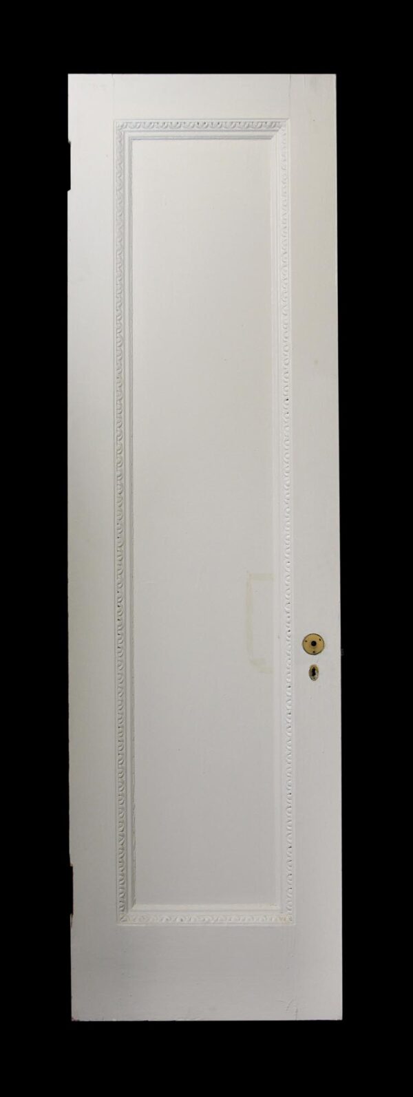 White wood passage door with one tall panel and egg and dart molding around the raised frame, shown front view with latch hardware visible on the right side.