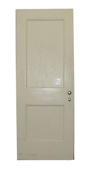 Vintage white wooden door with two recessed panels and a pair of visible hardware holes on the right side.
