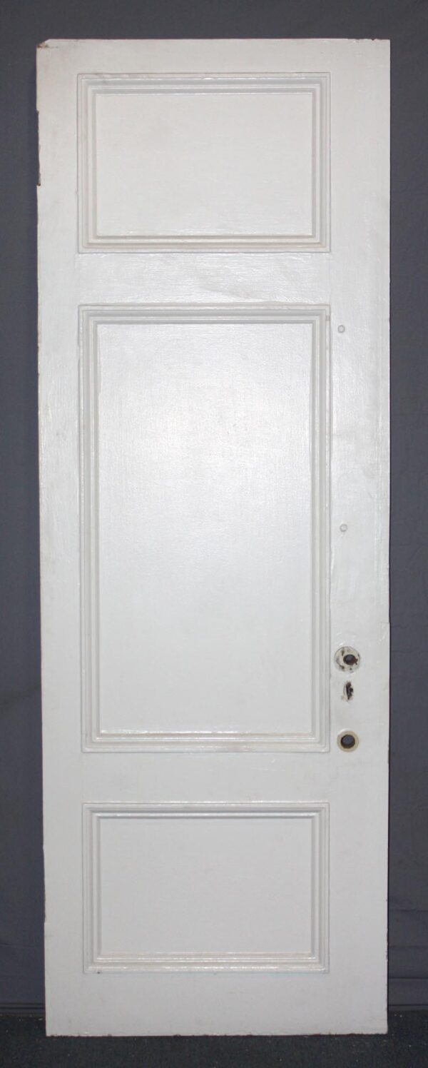 White wood privacy door with three raised panels, shown front view with hardware openings on the right side and a rectangular top panel.