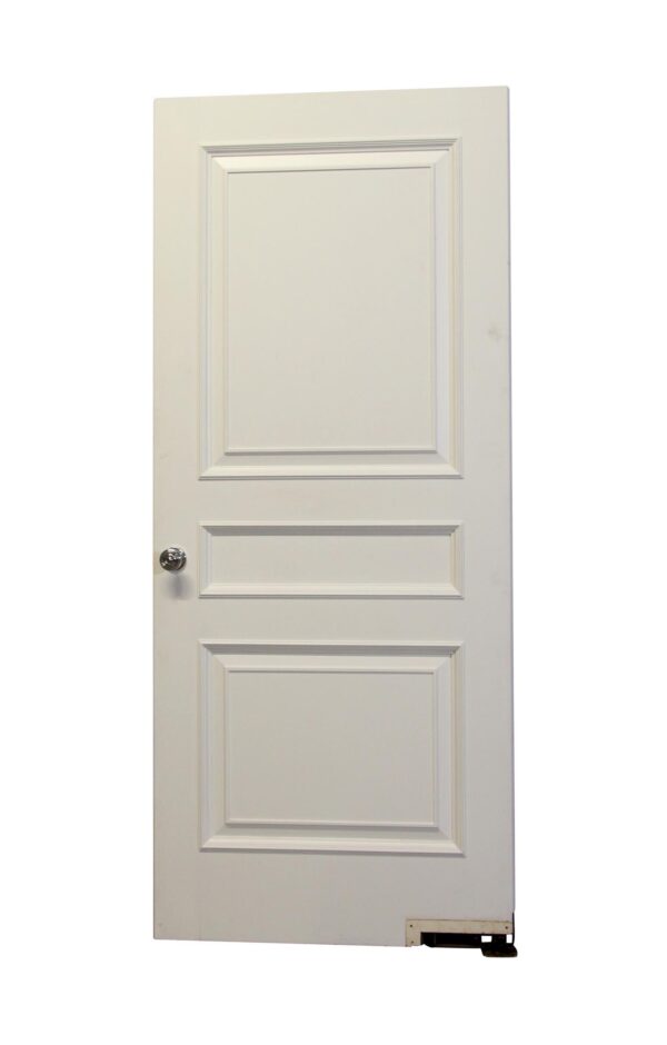 White wood passage door with three recessed panels and a knob on the left side, shown front view.