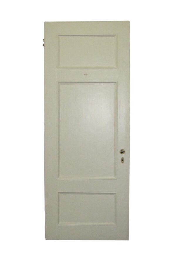 Vintage three-panel passage door with two small horizontal panels and one large center recessed panel, shown with hardware on the right side.
