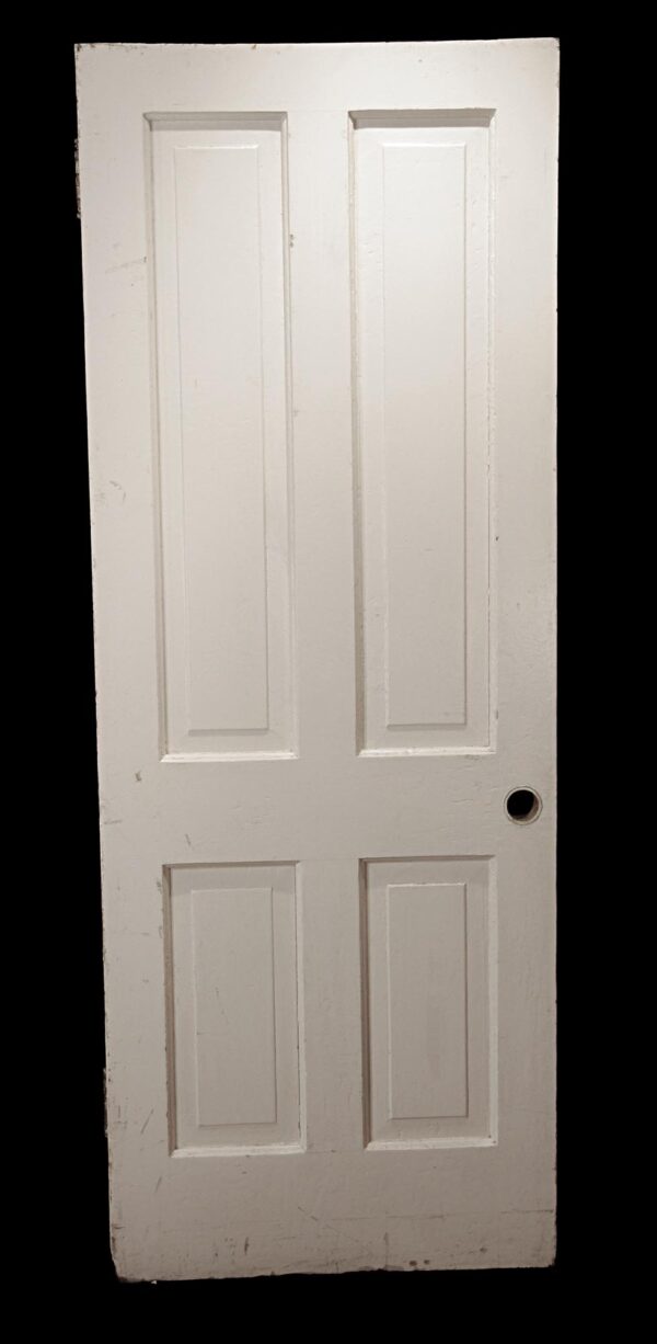 White painted wooden passage door with four vertical panels and no hardware attached.
