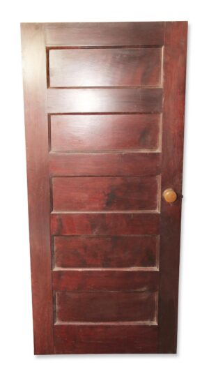 Vintage wood passage door with five panels and an original round knob on the right side.