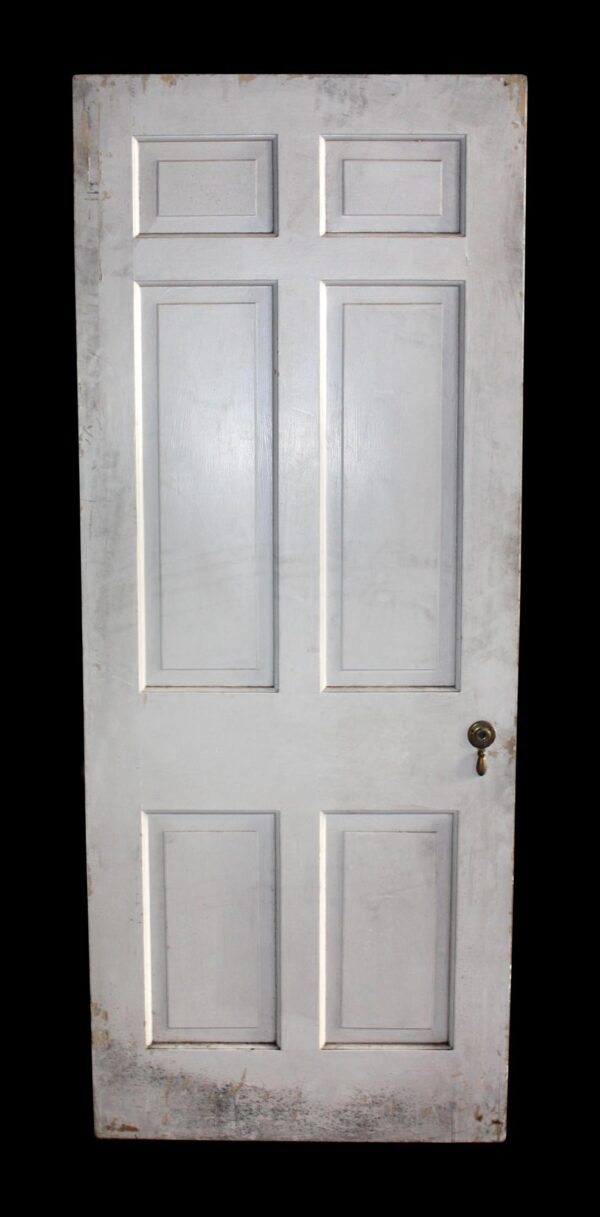 Six-panel white wood passage door with original hardware visible on the right side.