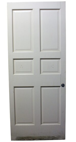 White six-panel wood passage door shown front on, with some original hardware still attached near the right edge.