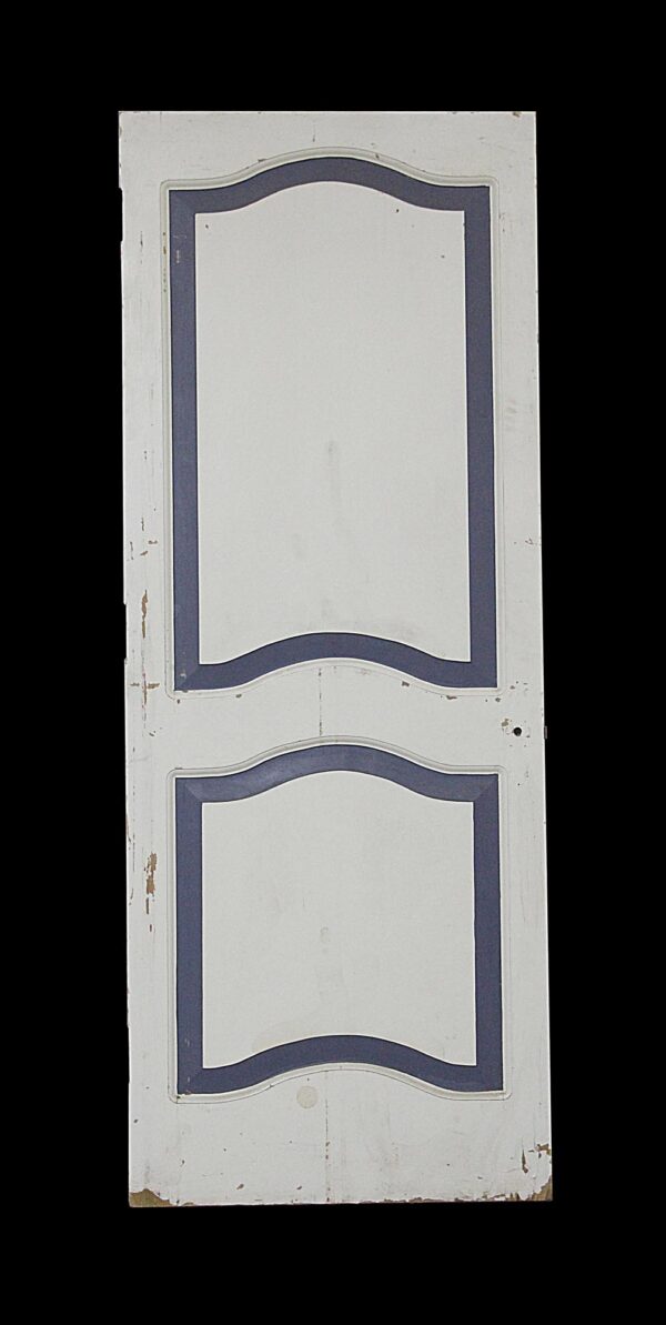 Painted white two-panel door with blue outlined arched panels and visible wear.