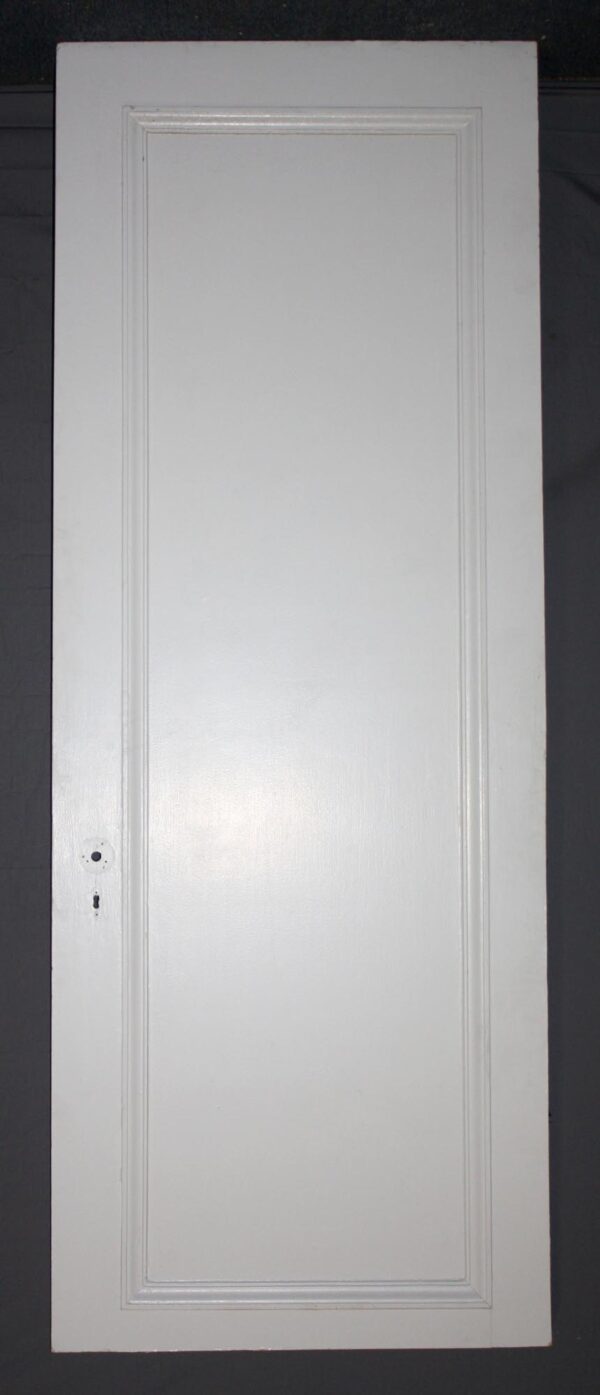 White wood passage door with one raised panel and a centered keyhole on the left side.