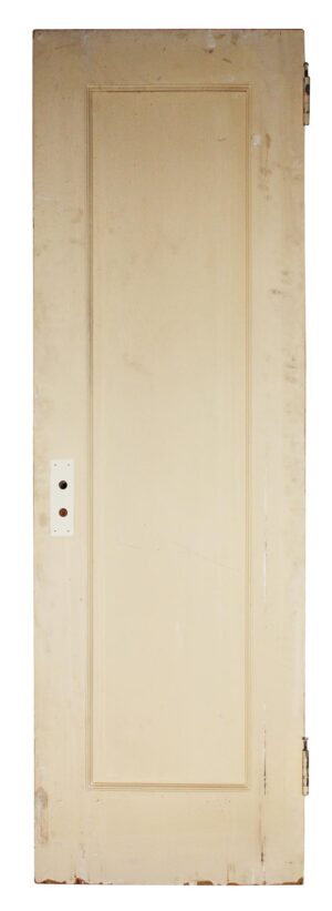 Vintage single-panel wood door with painted white finish and visible hinge and latch hardware cutout.