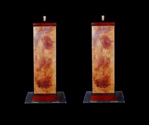 Pair of modern table lamps with tall rectangular bases, shown side by side and featuring copper and gold patina panels with wooden top and base sections.