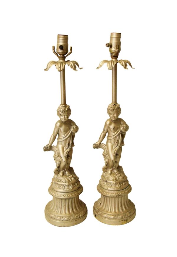 Pair of matching cherub table lamps with a gold finish, shown together in a front view.