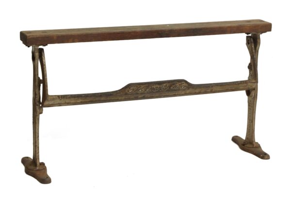 Vintage cast iron and wood wrapping paper tool with a long wooden top and metal folding frame, shown in profile with the Sheline Chicago inscription visible.