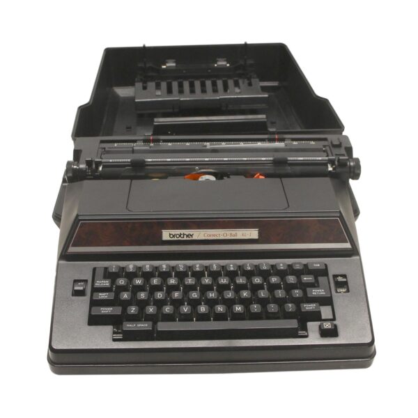 Black vintage Brother typewriter shown open with the keyboard and correction ball mechanism visible.